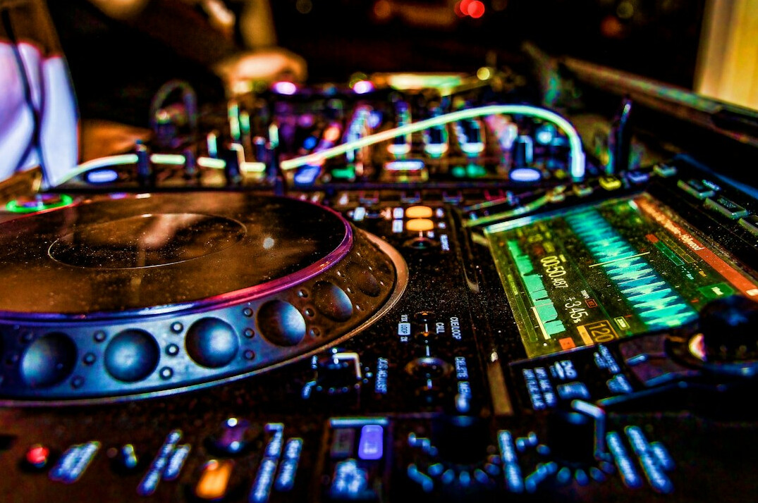 Audio mixing console with sliders and knobs in a sound studio